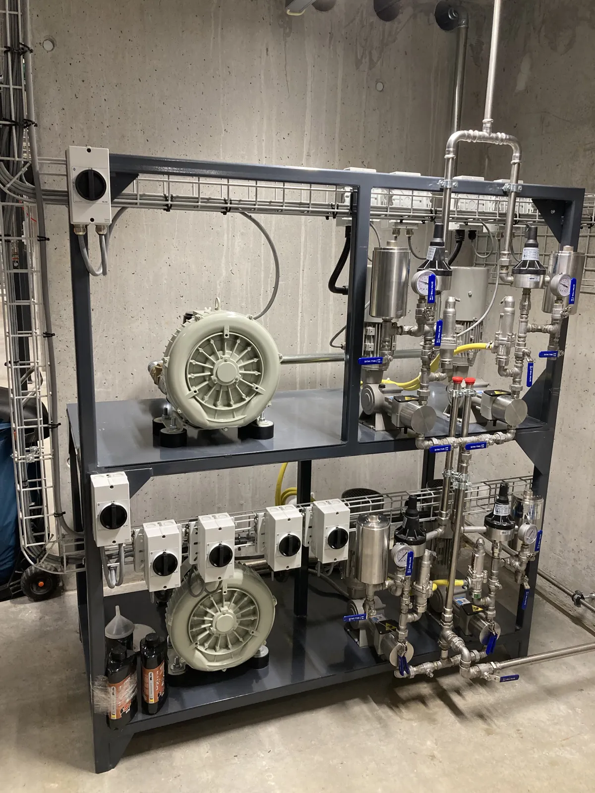 SNCR dosing skid installed in the plant room of the biomass plant, with metering pumps and cooling blowers – Switzerland